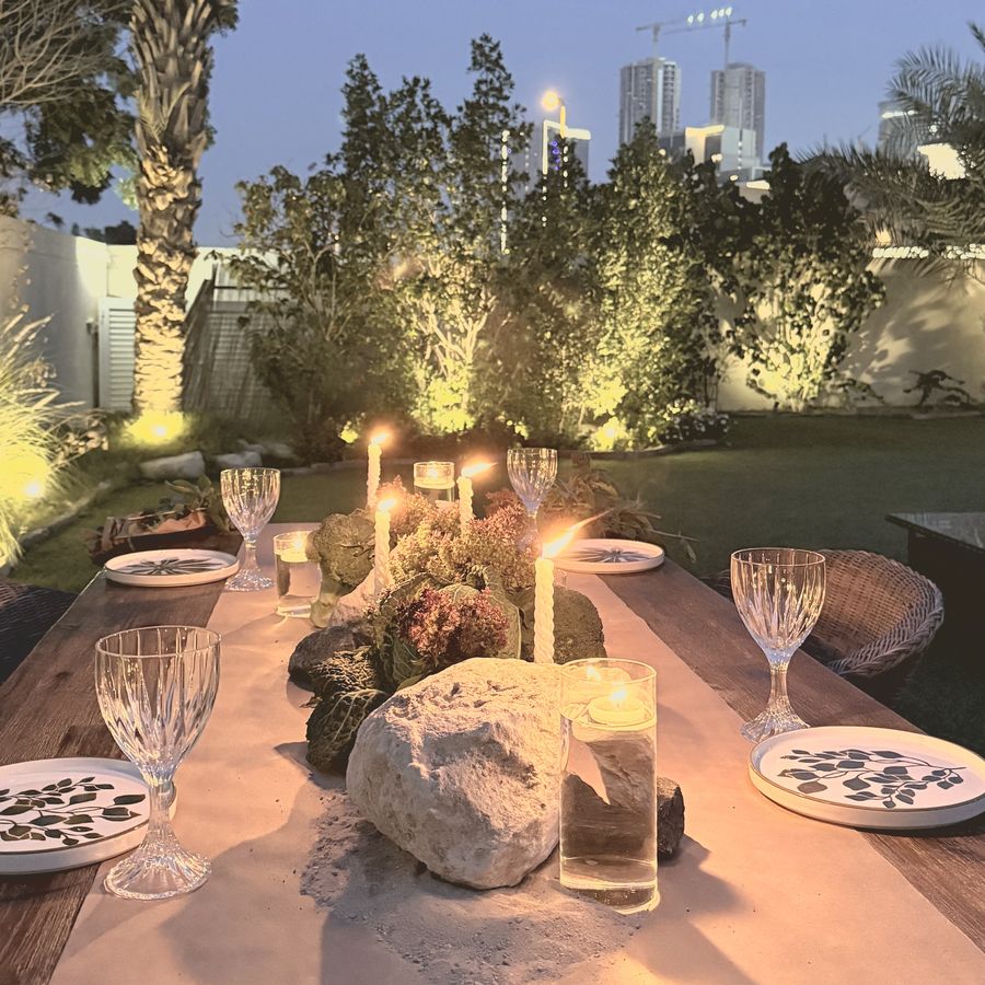 A candlelit garden table in the evening