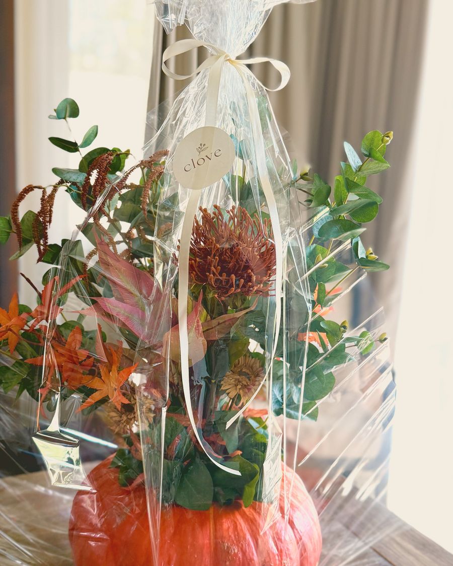 A small floral pumpkin wrapped as a hostess gift