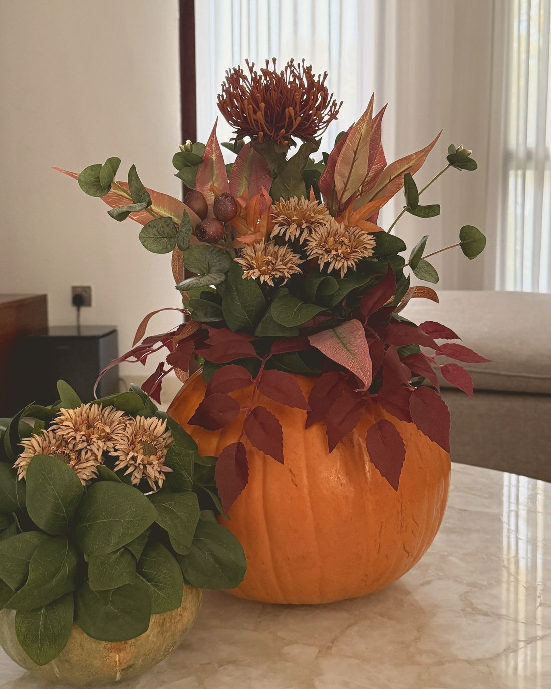 Two Clove Pieces: a floral pumpkin and a smaller arrangement
